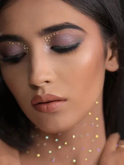 An eyes-closed shot that focuses on the delicate placement of the glitter on the eyelids.