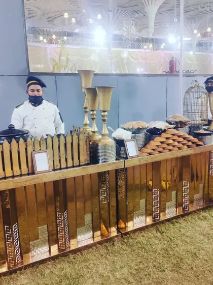 A high-tea setup with our staff ready to serve. This station offers a variety of snacks and beverages, perfect for afternoon functions or corporate events.