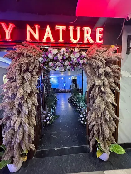 A grand entrance arch for the Punjabi By Nature inauguration, made with pampas grass and flowers for a rustic yet elegant look.