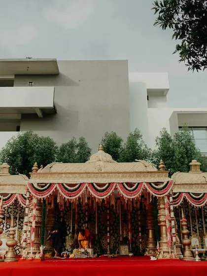 The grandeur of a temple mandap set against a modern home. This shot shows how we use our architectural eye to place magnificent traditional structures in any setting, creating a stunning contrast.