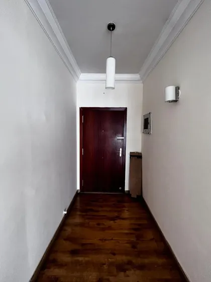 A 'before' shot of the narrow foyer in 'Cover me in Sunshine', which we transformed into a bright, welcoming, and highly functional entryway.