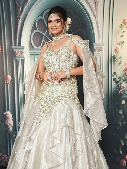 The full view of this mermaid-style gown shows the importance of creating a makeup look that matches the grandeur of the outfit.