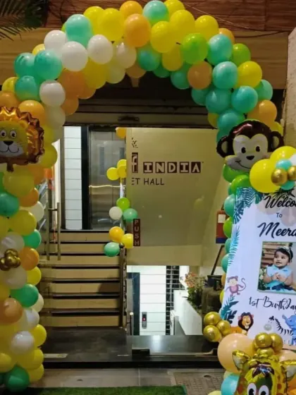 A jungle themed entrance arch for Meera's first birthday. The decoration features a colorful balloon arch with animal foil balloons and a welcome board.