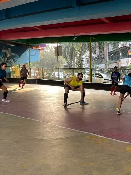 Players engage in a fast-paced drill during rink hockey practice. The enclosed space of the rink sharpens reflexes and encourages quick, decisive passing.