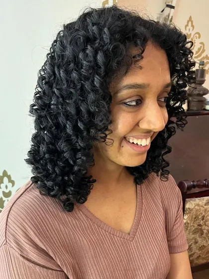 Tejaswini looking happy with her healthy, transformed curls.