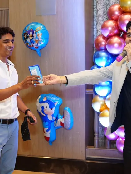 Awarding a prize to a game winner at a Sonic the Hedgehog themed birthday party.