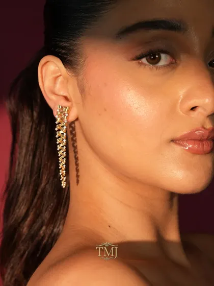 A model shot of my Tornado Earring. The spiraling gold and diamond design creates a sense of movement and drama, making it a truly unique piece of wearable art.