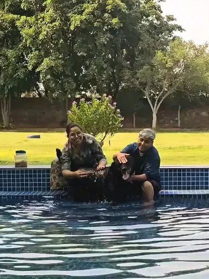 All smiles in the pool. This picture perfectly captures the joy and connection that a shared swim can bring to a family and their pet.