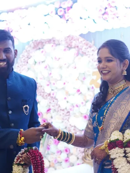 A playful moment during the reception. The bride's joyful expression is enhanced by a makeup look that is both beautiful and comfortable to wear.