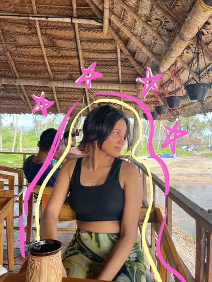 A chill moment at a beach shack, with pink and yellow doodles to brighten up the photo.