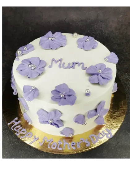 A lovely floral cake for "Mum" on Mother's Day. This mixed fruit cake is decorated with pretty purple piped flowers.