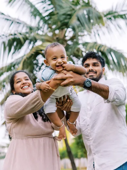 A family lifting their baby in the air. A playful and joyful moment that makes for a great photo.