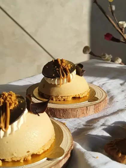 The sunlight catching these mini Biscoff cheesecakes really shows off their texture. They are a perfect two-bite dessert, great for dessert tables or as a fancy treat with coffee.