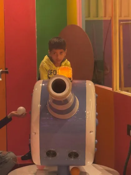 Manning the ball cannon. This is a fun and interactive feature within our play structure where kids can safely launch soft balls.