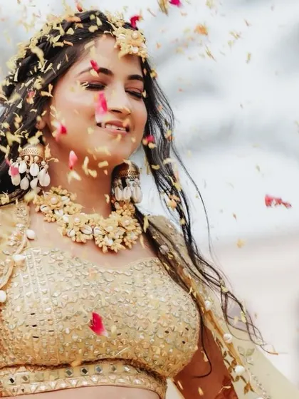 A close-up of the bride enjoying the shower of petals, a moment of pure happiness captured forever.