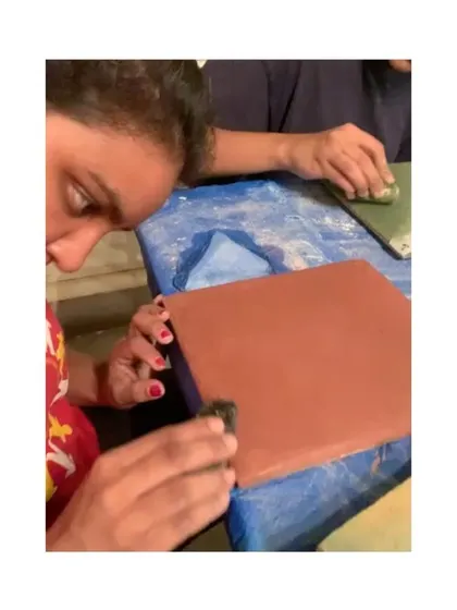 A duplicate image of a participant polishing a Tadelakt tile, experiencing the final step that gives the plaster its characteristic sheen.