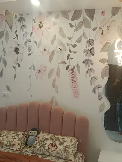 A beautiful watercolor floral mural creates a soft and artistic feature wall in this bedroom. The cascading flowers in pastel shades add a romantic and dreamy quality to the space.