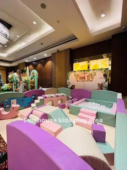 A wide view of the pastel play area at a jungle party, showing the full scale of the setup and how it creates an immersive play environment.
