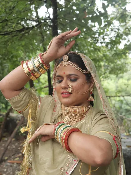 A dynamic pose capturing the artistry of the makeup and the flow of the traditional costume.