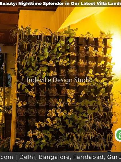A vertical garden on a villa's exterior, lit up at night. This shows how green walls can be a stunning feature even after dark.