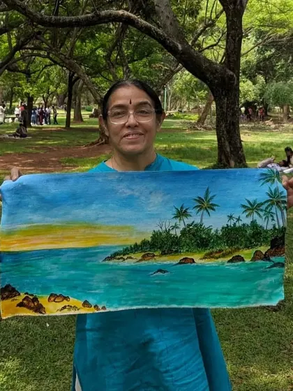 A fellow artist proudly displaying her beautiful seascape painting, created during our outdoor session. The vibrant blues and greens truly capture the feeling of being by the water.