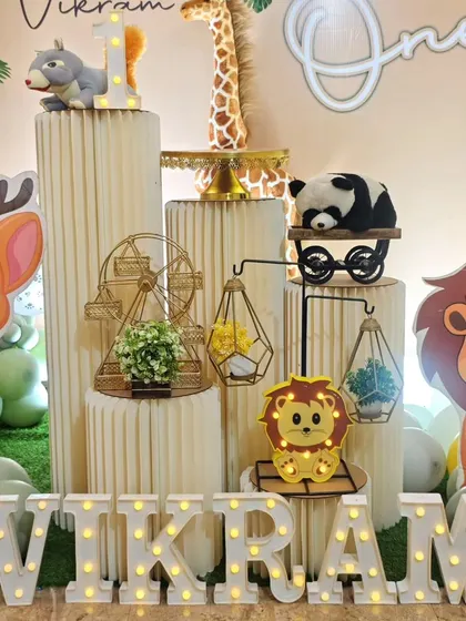 A close-up of the decor details for Vikram's party, including geometric terrariums and a mini Ferris wheel.
