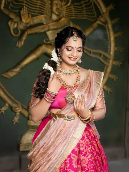 A close-up of the bride's serene expression. The makeup is soft and subtle, with a focus on enhancing her natural features and creating a gentle glow.