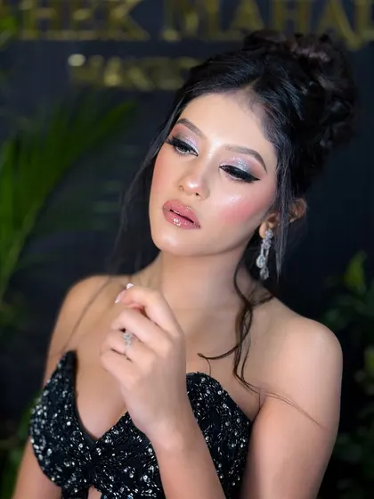 A close-up of the silver cut-crease eye makeup. The sharp lines and glitter make the eyes pop, creating a truly glamorous look.