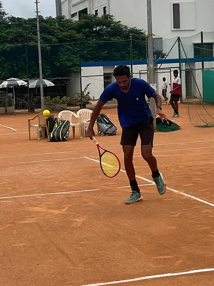 A player practicing a slice backhand approach shot. We train our athletes to be versatile, with the ability to change the pace and trajectory of the ball.