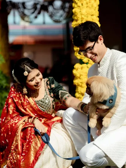 The couple shares a sweet moment with their adorable pet dog. This photo adds a personal and heartwarming touch, showing the family they are building together.