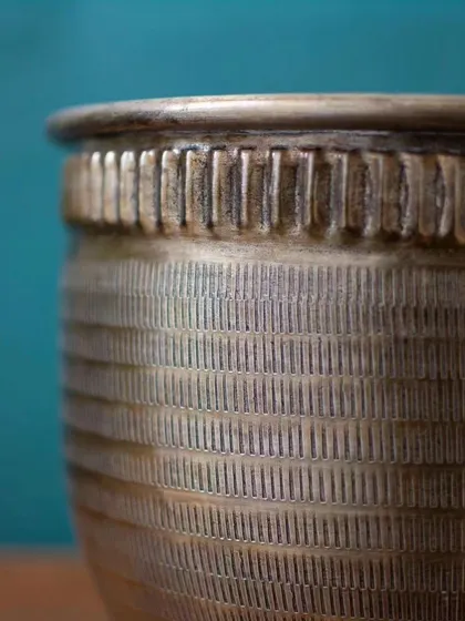 A close-up look at the intricate ribbed texture of my Baraaz Bronze Finish Planter. The detailed craftsmanship adds a layer of sophistication and depth to the piece.