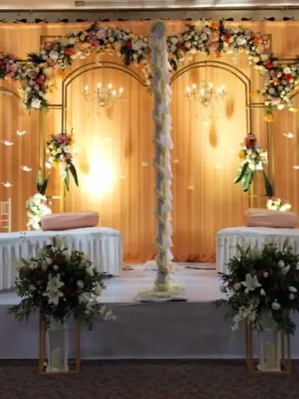 A variation of the golden backdrop stage, this time set up with traditional low seating (diwans) for a more classic and intimate feel.