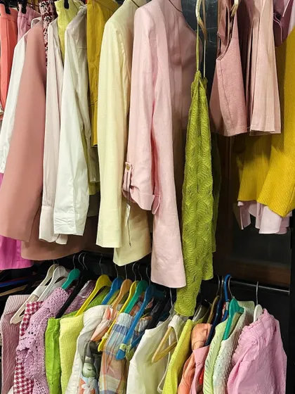 A snapshot of my clothing rack on a busy shoot day. It's organized chaos, with a rainbow of options ready for the next look.