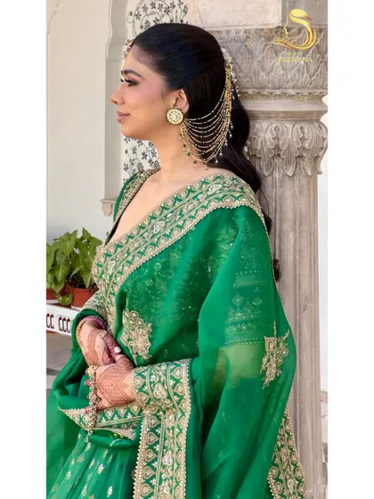 A side profile of the gajra half-tie, showing how the kaan chain earring connects to the hair for a regal and cohesive look.