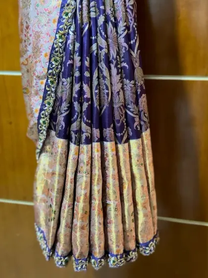 A stunning set of pre-pleated saree, showcasing the rich texture and color combination.