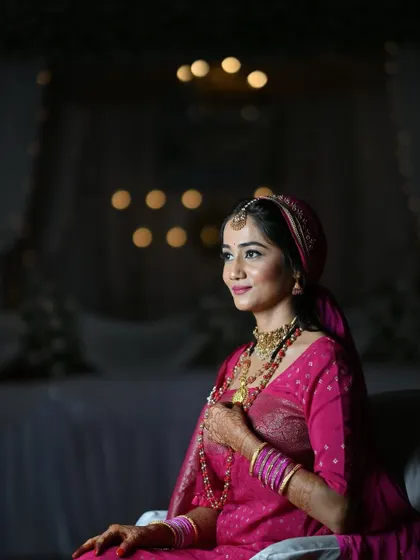 A smiling portrait of the bride. Her makeup is fresh and glowing, and she looks happy and relaxed.