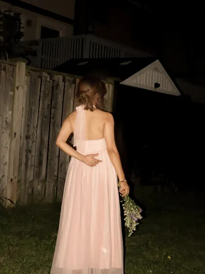 A final shot of the pink Jardinvue dress, showing the back and halter-tie detail.