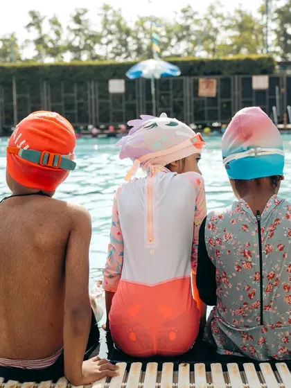 Our summer camp is a place to grow, learn, and swim. Here, young swimmers wait for their turn, ready to practice their new skills.