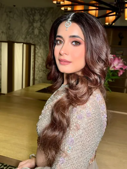 Another angle of this beautiful reception makeup. The skin looks flawless and the soft waves in her hair complete this glamorous and trendy look.