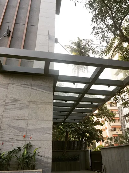 We designed a sleek glass and metal canopy at the building's entrance to protect the car lift doors from the weather while complementing the modern façade design.
