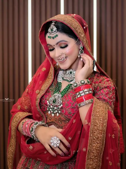 A beautiful candid-style shot of the bride smiling as she adjusts her earring. This captures a natural, unposed moment that feels authentic and full of life.