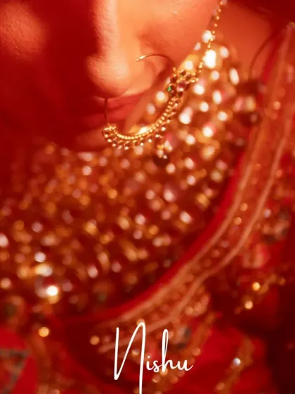 A soft-focus, artistic shot of a bride's nath and the delicate details of her bridal jewelry.