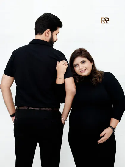 A different angle of the same intimate pose, showing the mom-to-be's happy expression. These candid-style moments are what make a session special.