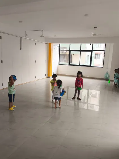 Children practice throwing and catching with soft balls in our bright and airy studio. This simple activity is great for developing hand-eye coordination.