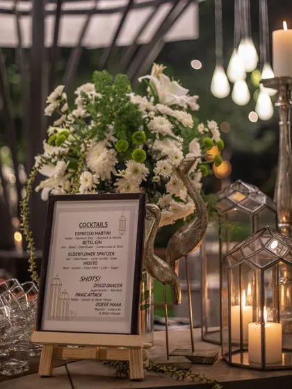A close-up of the bar menu for a cocktail night, featuring custom drinks like Espresso Martinis and Elderflower Spritzers.
