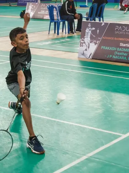 A young shuttler shows intense focus during the PSM Open Junior Badminton Tournament. These events are designed to build competitive experience and mental toughness from a young age.