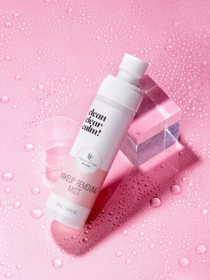 To highlight the hydrating quality of this makeup removing mist, we surrounded it with water droplets on a matching pink surface. The acrylic block adds a modern, geometric element that contrasts beautifully with the organic feel of the water.