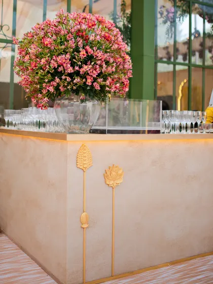 The bar at the reception, featuring a textured finish and gold floral motifs that tied in with the elegant and soft aesthetic of the evening.