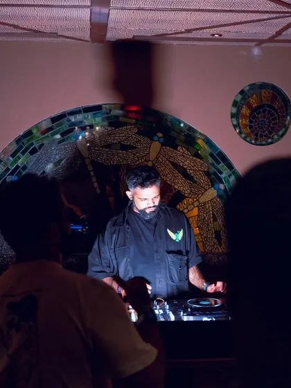 A shot of me at the decks at Waikiki, with the club's beautiful mosaic art in the background.