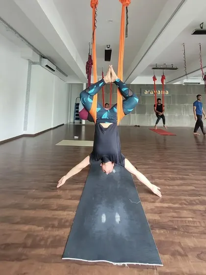 An upside down perspective from our aerial yoga class. Inversions like this help decompress the spine and bring fresh oxygen to the brain, leaving you feeling refreshed and energized.